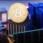Photo of bitcoin and processor on dark background
